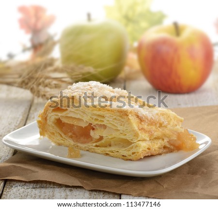Slice Of An Apple Strudel In A White Dish