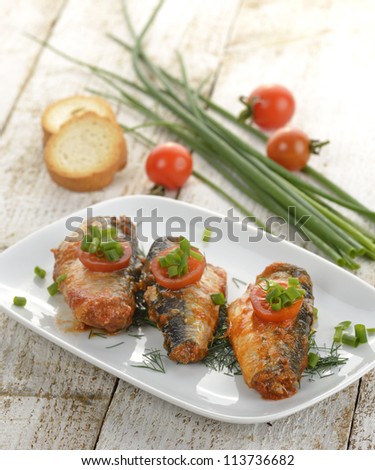 Sardines In Tomato Sauce On A White Dish