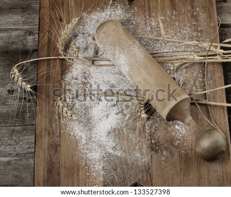 Wooden Rolling Pin, Flour And  Wheat On A Wooden Board