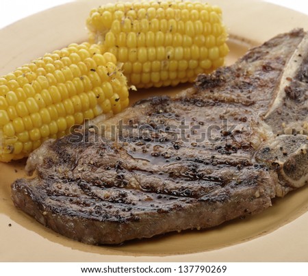 A Grilled Rib Eye Steak With Corn