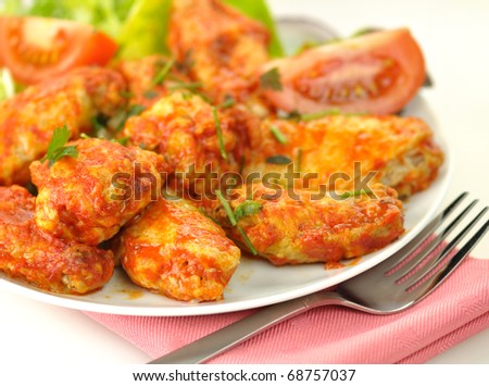 hot chicken wings with salad close up