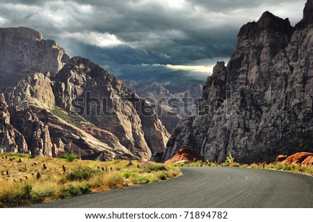 road to mountains and dramatic sky