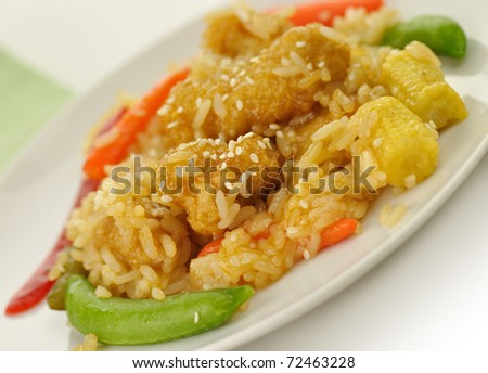 white meat chicken with rice ,vegetables and sesame seeds in a mandarin sauce