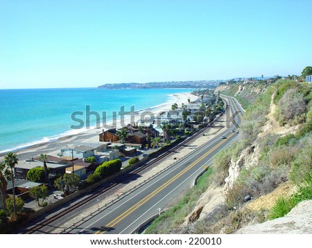 A HILLTOP VIEW OF PACIFIC PALISADES AND PACIFIC COAST HIGHWAY IN THE SUMMERTIME