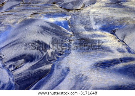 This is an image of the sand on the pacific coast, right after the water has ran back into the ocean.