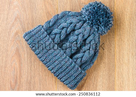 knitting cap on wooden background