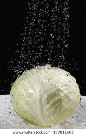 White cabbage under jet of water