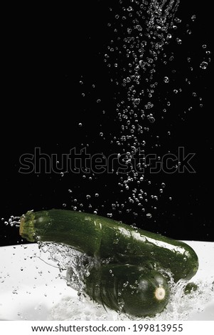Zucchini under jet of water, close up