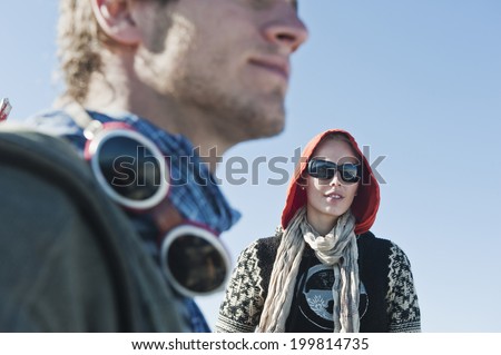 Austria, Steiermark, Dachstein, Woman wearing sunglasses and hood, man in foreground