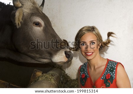 Young woman with cow, portrait