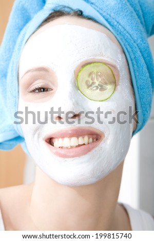Woman applying beauty mask, close-up