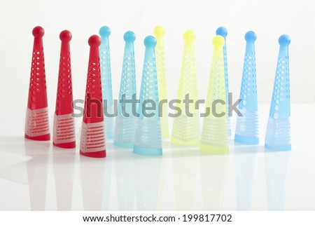 Multi-colored hair curlers on white background