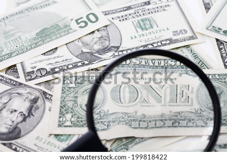 US Dollar bills seen through magnifying glass, close up