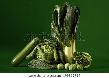 Leafy vegetables against green background