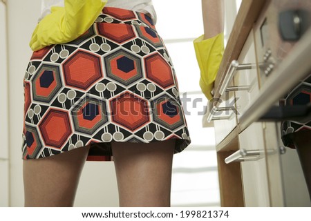Woman wearing mini skirt and rubber gloves