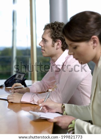 Man and woman working in office