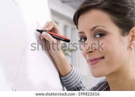Woman writing on flip chart