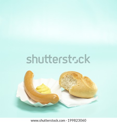 German Bockwurst, sausage and bread with mustard in paper plate