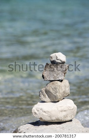 Germany, Bavaria, Walchensee, stones piled up on lake shore