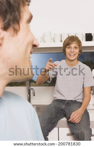 Father and son man smiling boy pointing