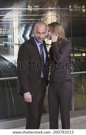 Germany, Bavaria, Munich, business man and business woman at subway station woman talking to man using mobile phone