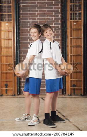Boys holding medicine balls
