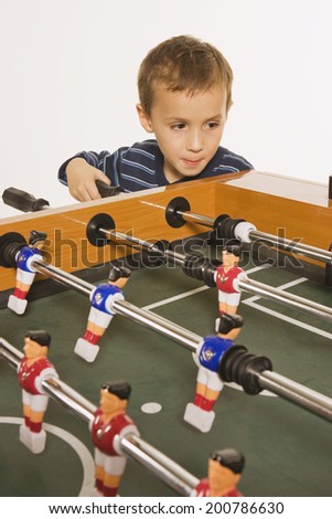 Little boy (4-5) playing tabletop soccer