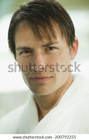 Man in bathrobe smiling