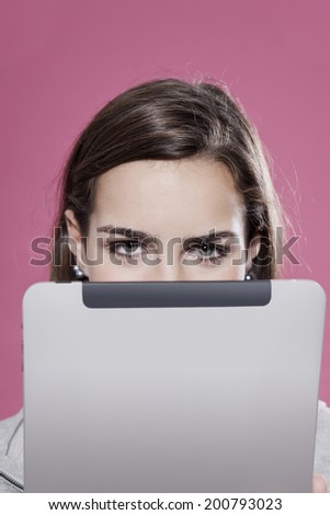 Cute teenage girl using digital tablet face obscured close up