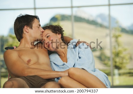 Man kissing on forehead of woman