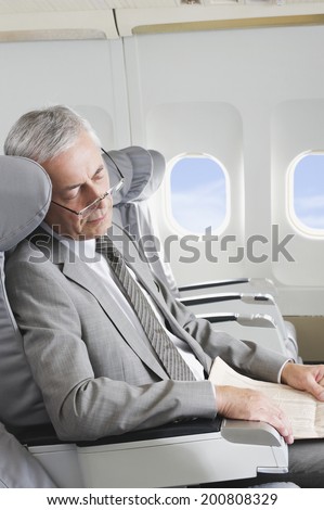Senior passenger sleeping on airplane