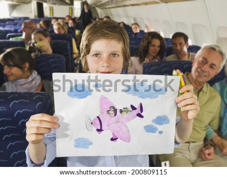 Boy showing airplane drawing on airplane