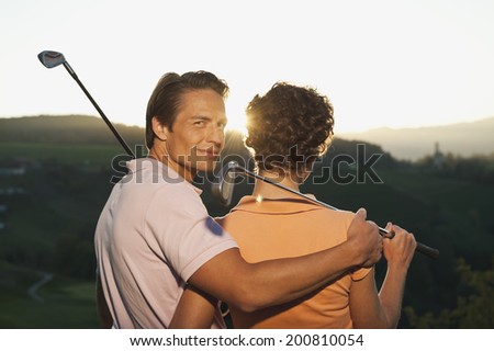 Italy, Kastelruth, couple standing on golf course