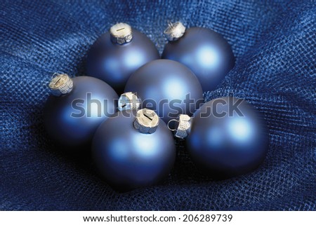 Blue christmas baubles on blue blanket