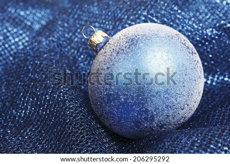 Blue christmas bauble on blue blanket