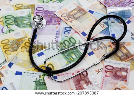 Stethoscope on heap of euro notes