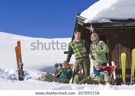 Italy, South Tyrol, Seiseralm, Persons in front of log cabin, holding champagne glasses