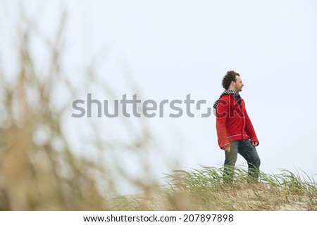 Germany St Peter-Ording North sea man standing on sand dune looking away