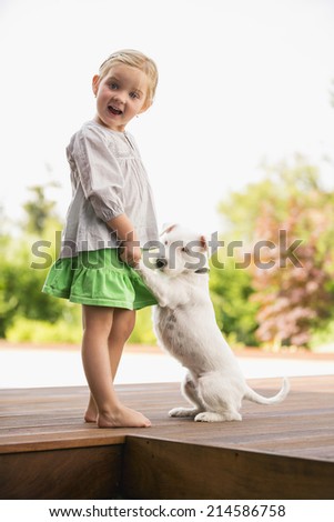 Young girl dancing outside with her dog