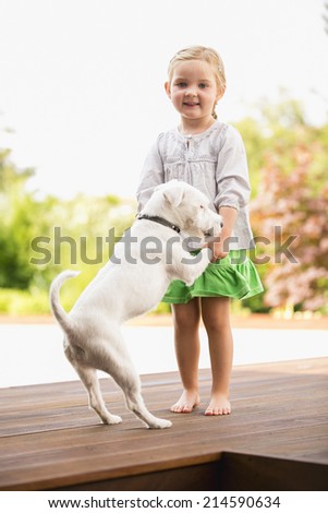 Young girl dancing outside with her dog
