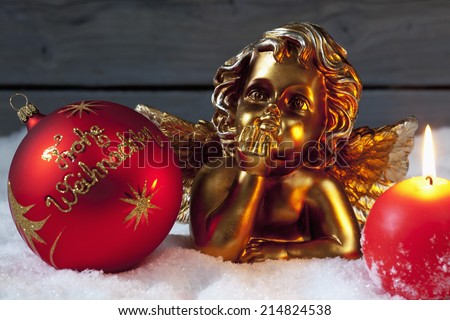 Christmas bulb burning candle golden putto on pile of snow