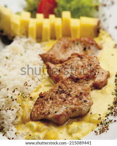Turkey hen filet garnished with rice, pineapple and curry sauce