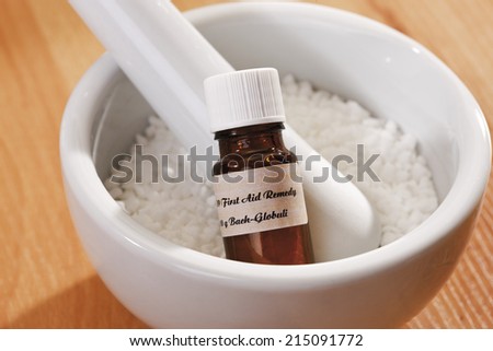 Granulate and bottle with Homeopathic remedy in mortar