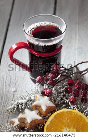 Mulled wine with cinnamon stars cinnamon sticks rose hips on wooden background
