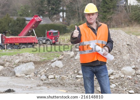 Project manager showing thumbs up sign at construction site