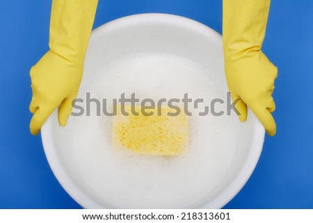Hands wearing rubber gloves, Holding plastic bowl