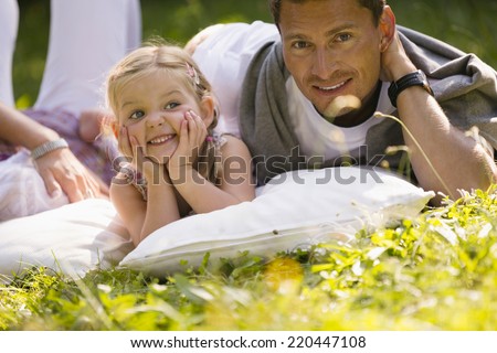Father and daughter relaxing in garden