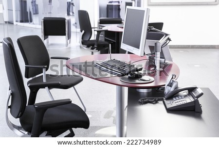 Empty open-plan office with desks chairs computers