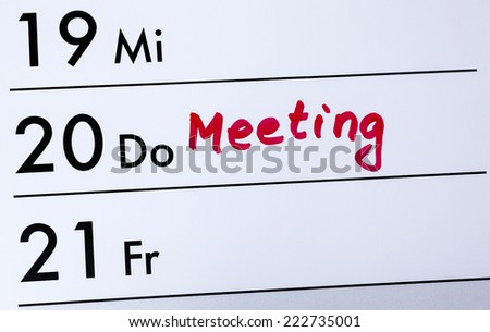 Calendar entry, meeting written with red color, close up, detail