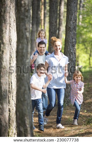 happy family taking a walk in forest
